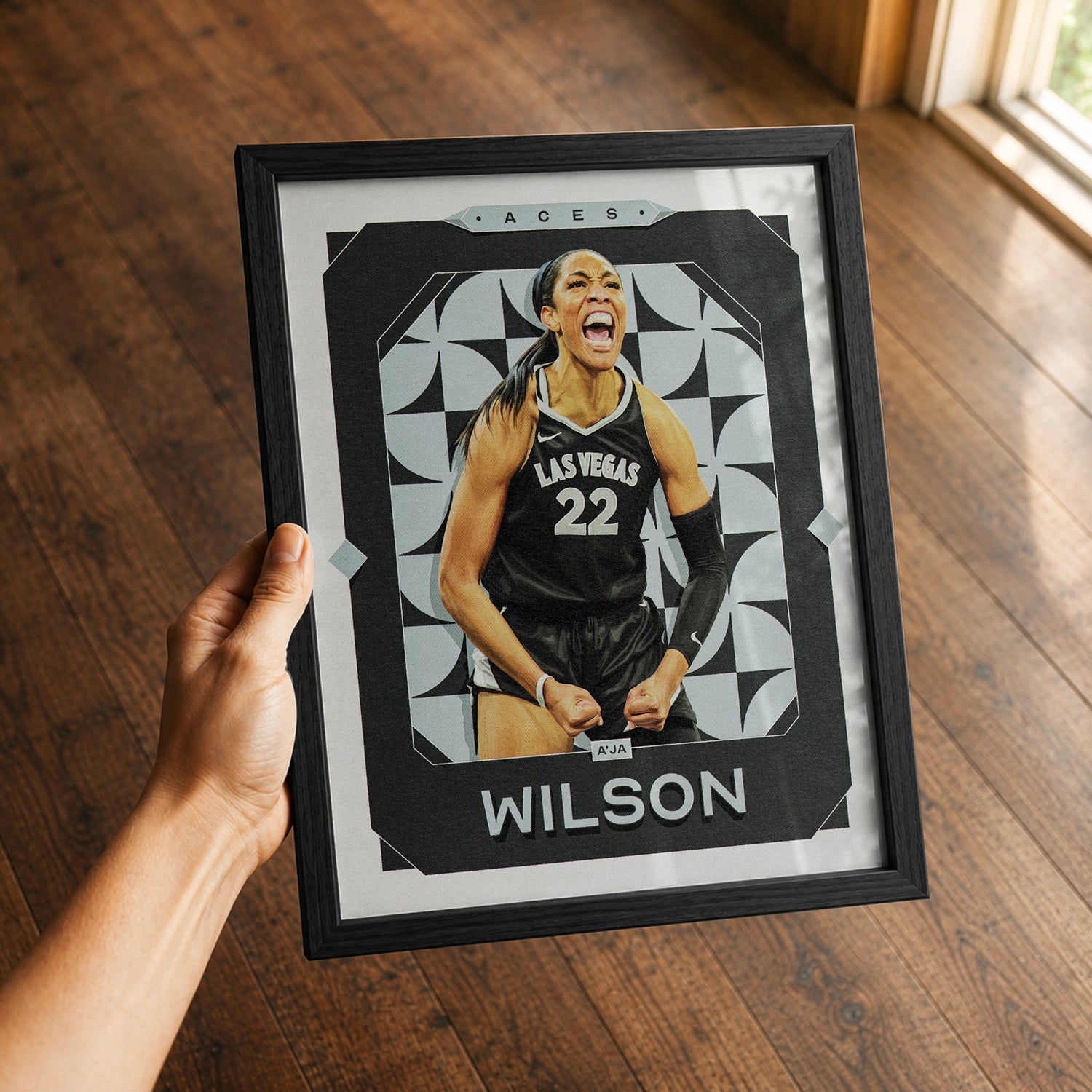 A premium A'ja Wilson poster in a 8x10 frame being gifted to a Las Vegas Aces fan.