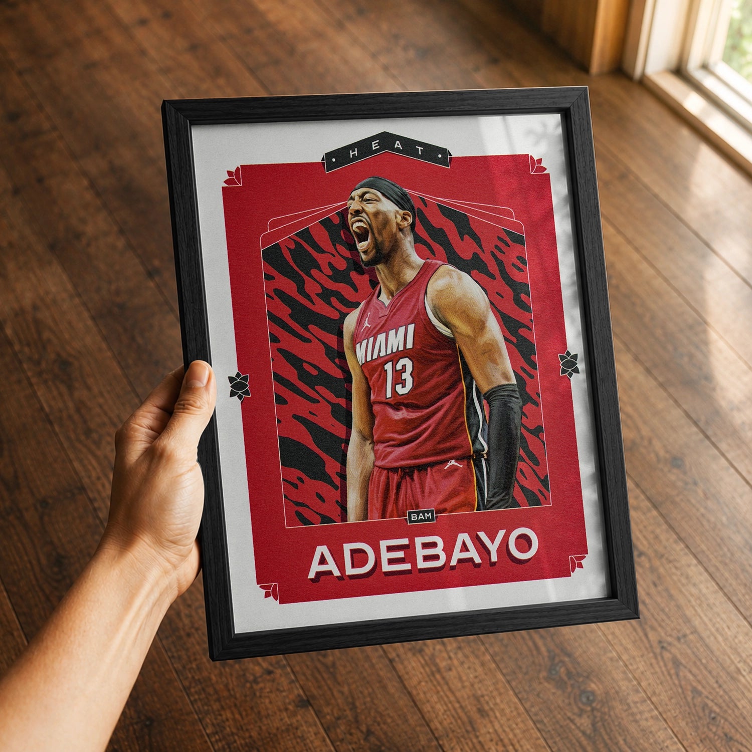 A premium Bam Adebayo poster in a 8x10 frame being gifted to a Miami Heat fan.
