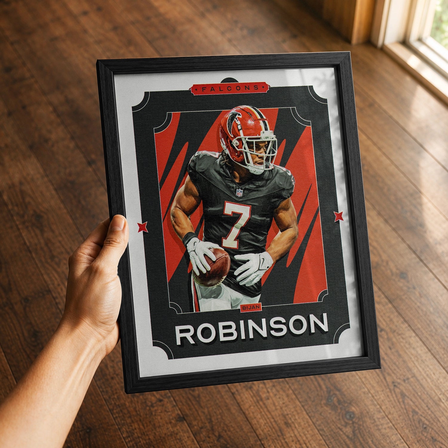 A premium Bijan Robinson poster in a 8x10 frame being gifted to a Atlanta Falcons fan.