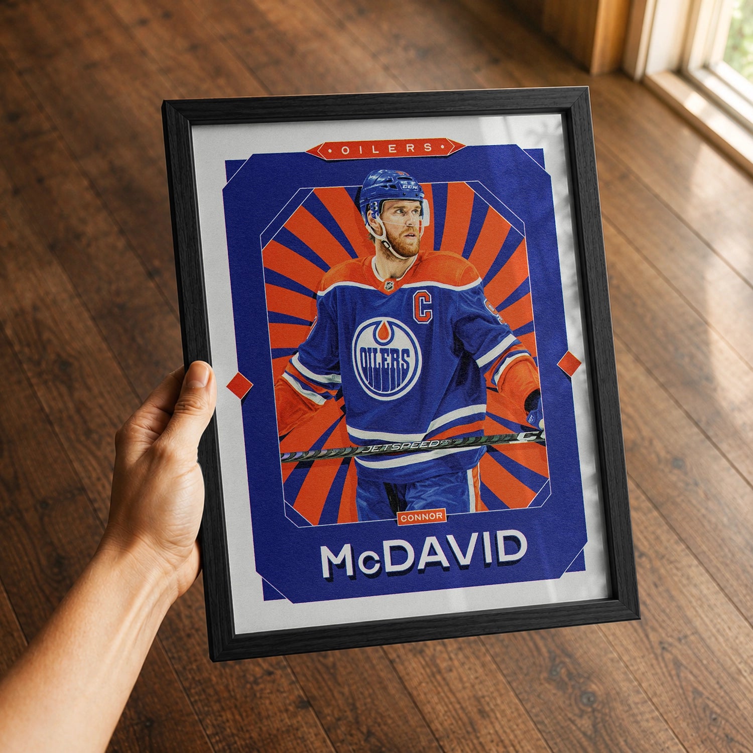 A premium Connor McDavid poster in a 8x10 frame being gifted to a Edmonton Oilers fan.