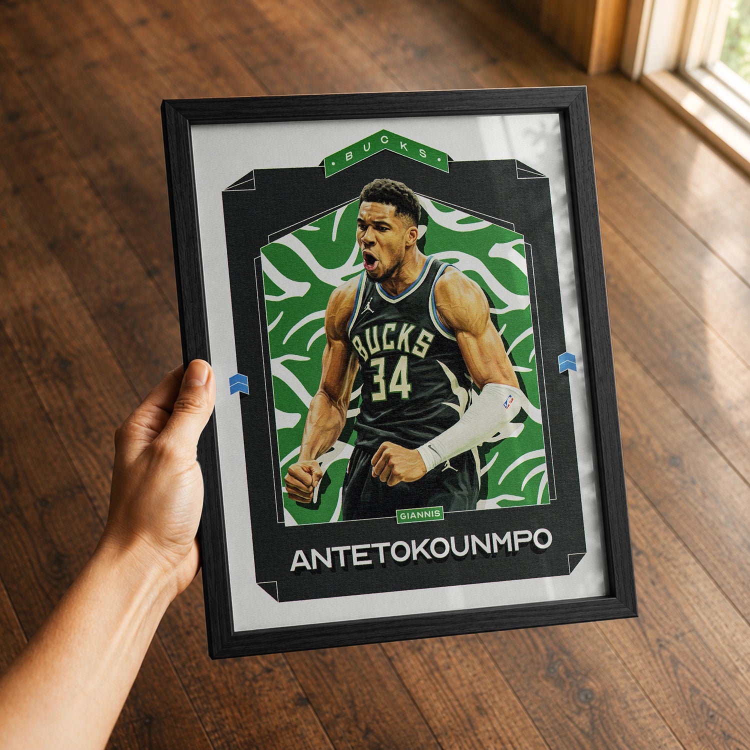 A premium Giannis Antetokounmpo poster in a 8x10 frame being gifted to a Milwaukee Bucks fan.