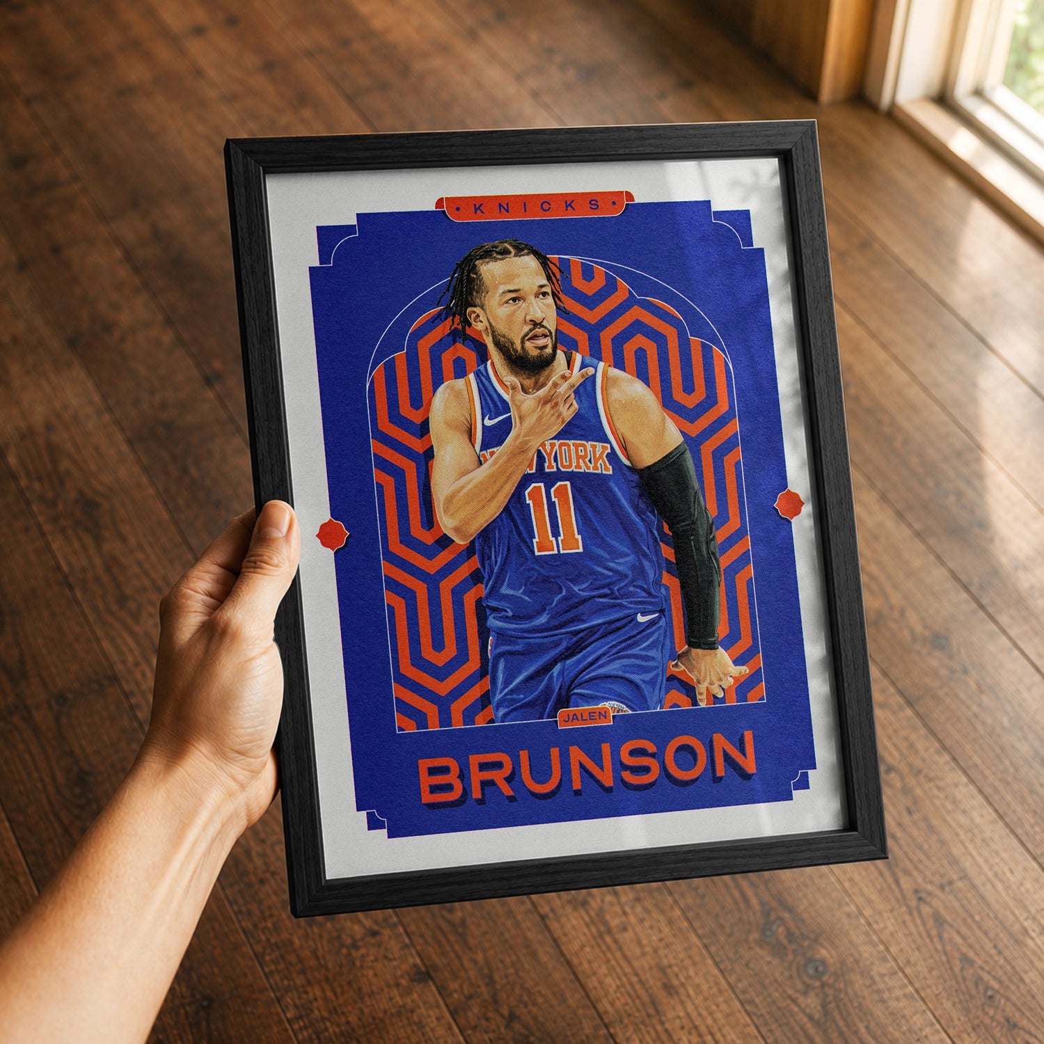 A premium Jalen Brunson poster in a 8x10 frame being gifted to a New York Knicks fan.
