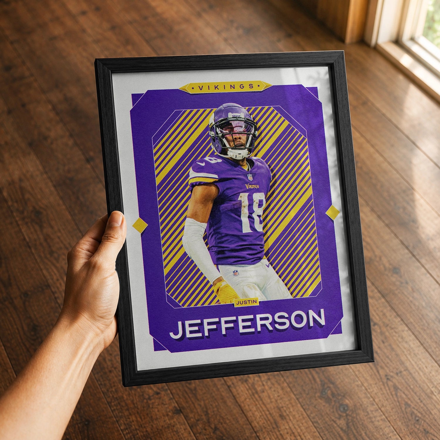 A premium Justin Jefferson poster in a 8x10 frame being gifted to a Minnesota Vikings fan.