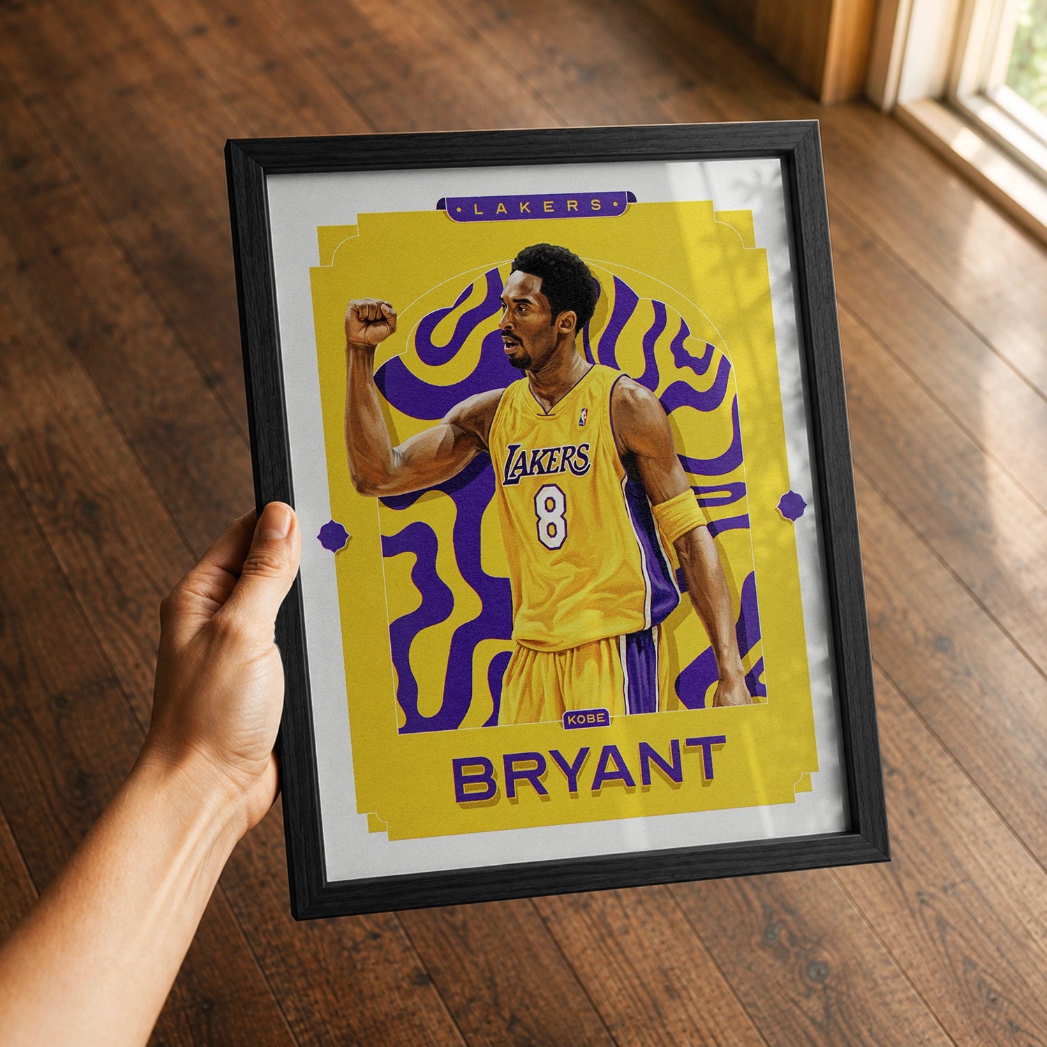 A premium Kobe Bryant poster in a 8x10 frame being gifted to a Los Angeles Lakers fan.