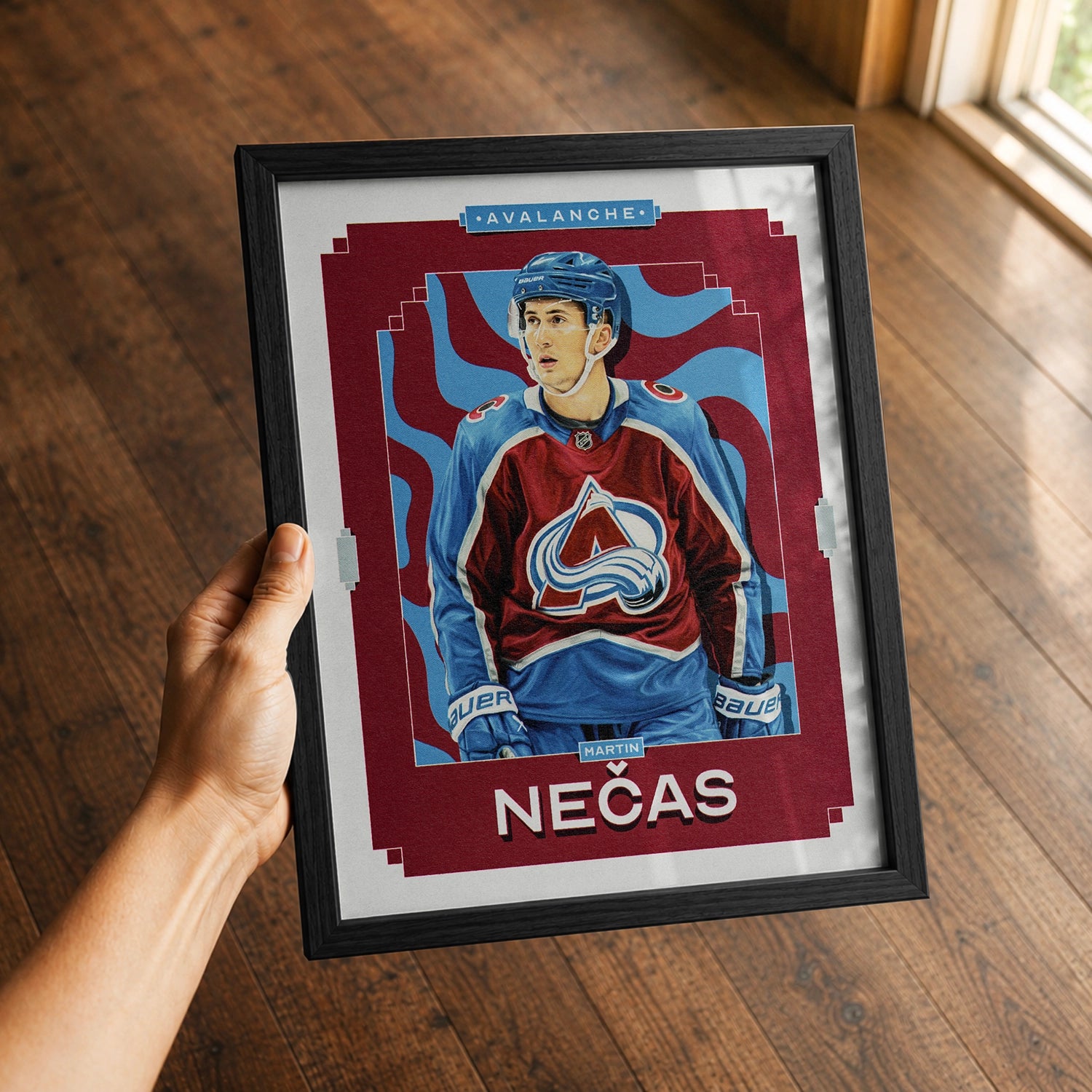 A premium Martin Necas poster in a 8x10 frame being gifted to a Colorado Avalanche fan.