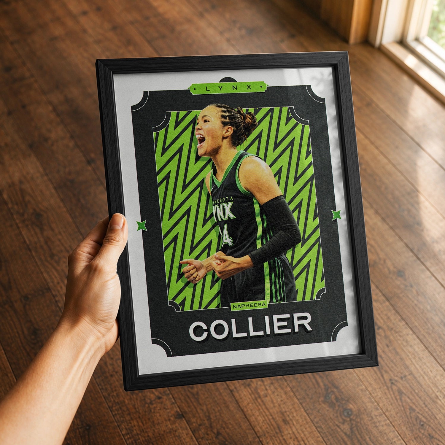 A premium Napheesa Collier poster in a 8x10 frame being gifted to a Minnesota Lynx fan.