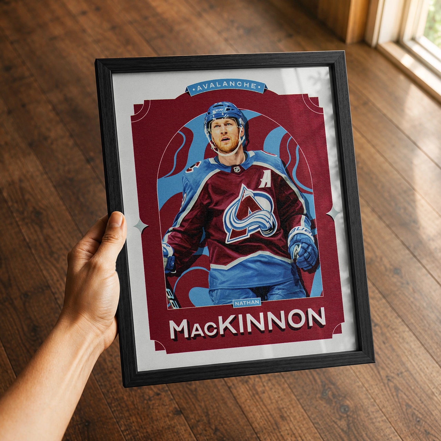 A premium Nathan MacKinnon poster in a 8x10 frame being gifted to a Colorado Avalanche fan.