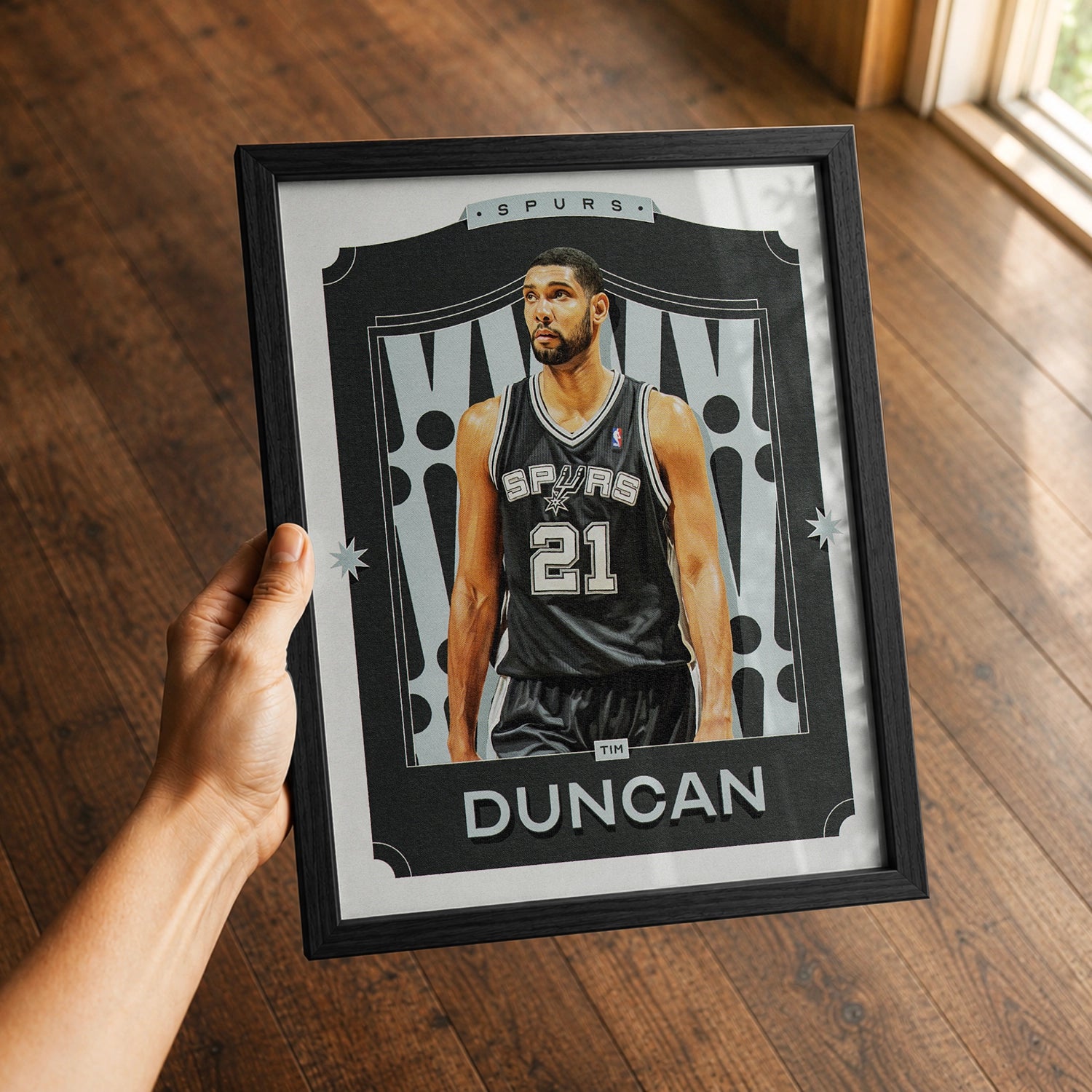 A premium Tim Duncan poster in a 8x10 frame being gifted to a San Antonio Spurs fan.