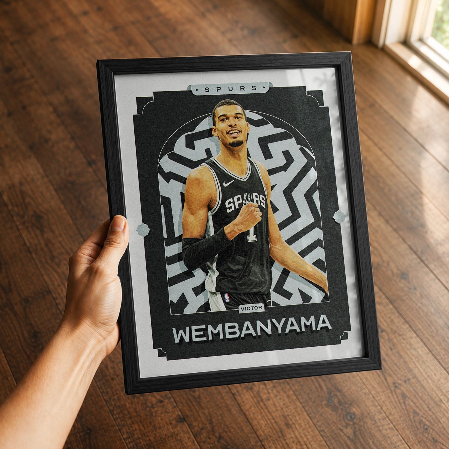 A premium Victor Wembanyama poster in a 8x10 frame being gifted to a San Antonio Spurs fan.