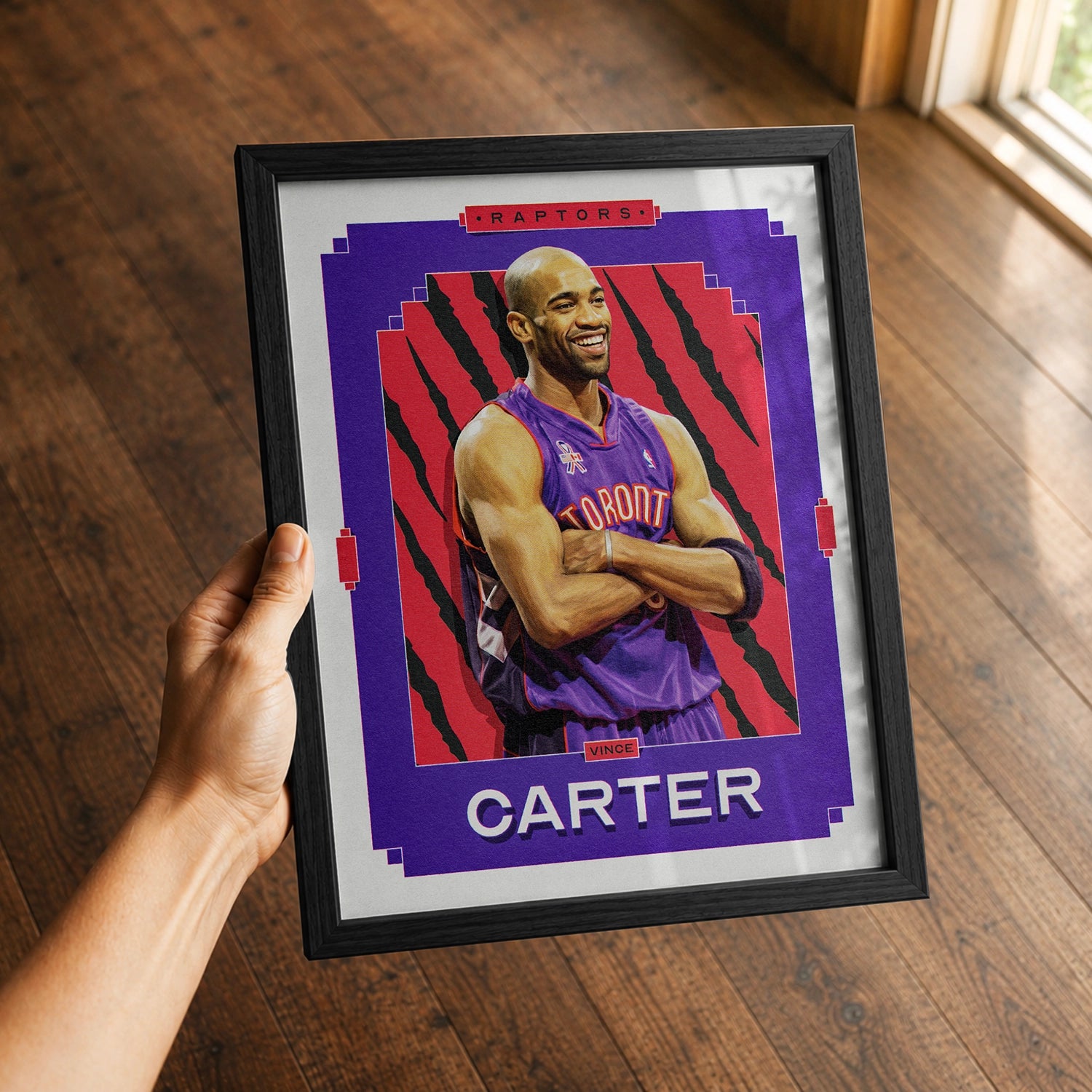A premium Vince Carter poster in a 8x10 frame being gifted to a Toronto Raptors fan.